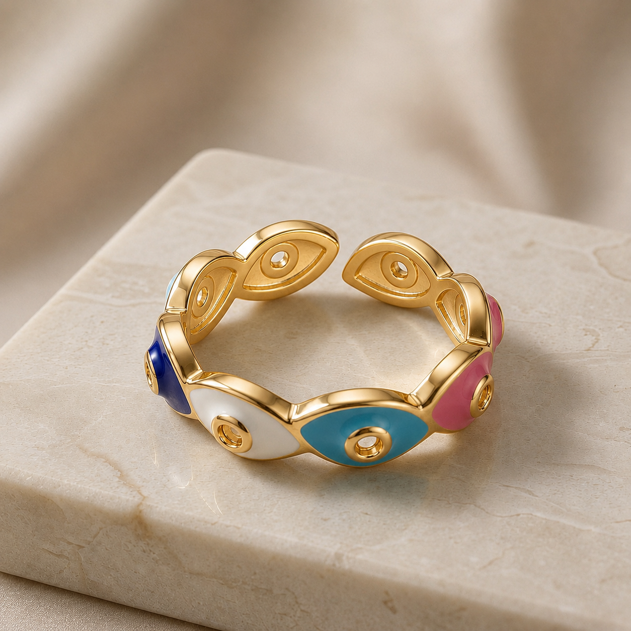 Chromatic Evil Eye Eternity Ring - top-down view on marble showing multicolour enamel evil eyes and gold dividers