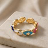 Chromatic Evil Eye Eternity Ring - top-down view on marble showing multicolour enamel evil eyes and gold dividers