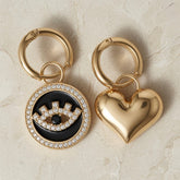 Heart & Evil Eye Mismatched Hoop Earrings - both charms flat lay on marble top-down view