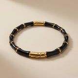 Noir Bamboo Enamel Bangle - angled flat lay showing clasp detail