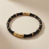 Noir Bamboo Enamel Bangle - front flat lay showing gold connectors