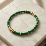 Vert Bamboo Enamel Bangle - top-down flat lay on white marble