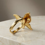 Fleur Gold Bloom Ring - back angle on marble showing open band and inner petal structure