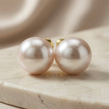 Perle Blush Pearl Stud Earrings - front view pair on marble with silk backdrop showing full blush pearl lustre and size