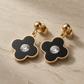 Noir Fleur Crystal Drop Earrings - pair on travertine showing black enamel flower and crystal centre with gold ball stud