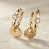 Disque Crystal Huggie Drop Earrings - pair on travertine showing rectangular huggie hoop, milgrain crystal and interlocked disc charm