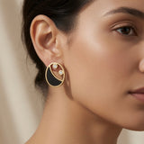 Lunaire Noir Crystal Stud Earrings - worn on model ear showing scale, flat profile and black gold crystal detail against skin