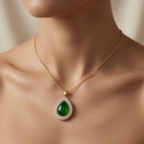 Impériale Jade Pavé Necklace - worn on model collarbone showing emerald green cabochon pendant at chest centre, double halo pavé fire and gold cable chain