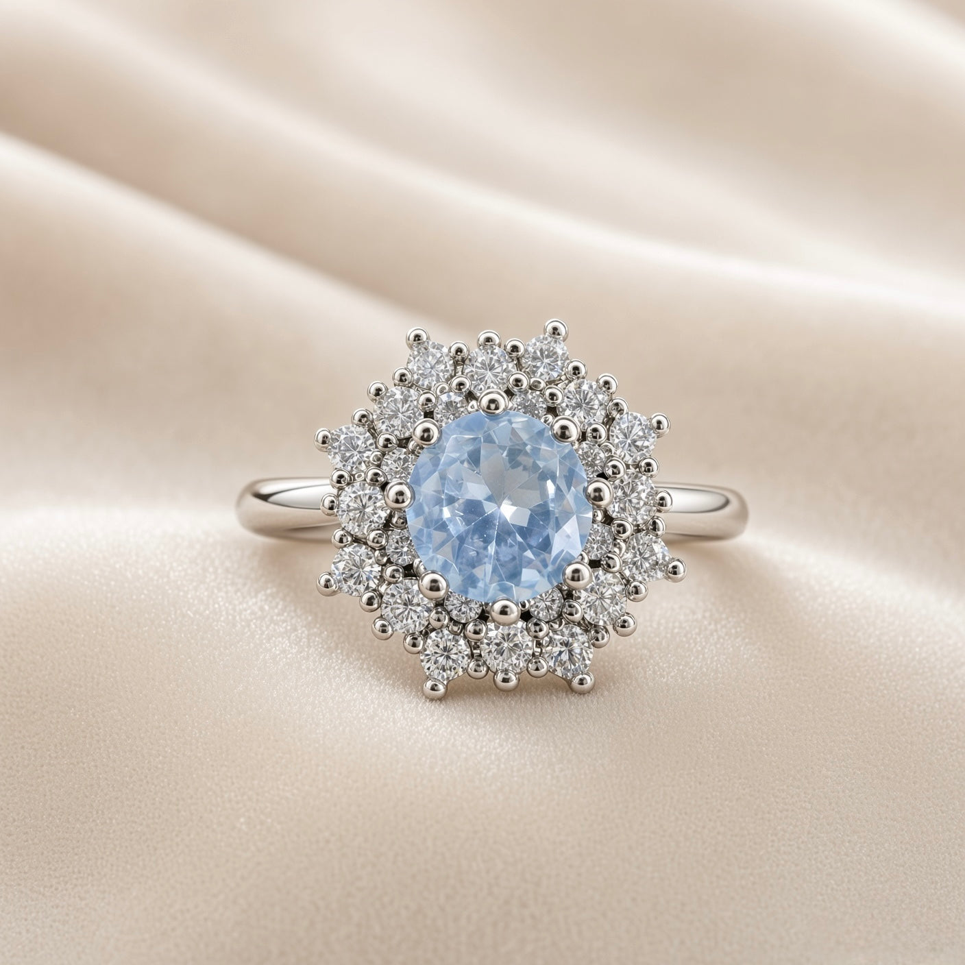 Sky Blue Crystal Snowflake Halo Ring - face-on on ivory satin showing complete ring: round pale sky blue crystal zirconia centre stone in multi-prong setting surrounded by dramatic double starburst halo of round brilliant white crystal zirconia stones and polished silver ball details radiating in snowflake pattern, plain polished round-wire silver band