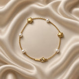 Gold Star and Pearl Station Bracelet Milgrain - macro detail on cream satin: puffy three-dimensional milgrain bead border gold star charm with mirror-polish domed surface and round white freshwater pearl station on fine gold cable chain, star milgrain border detail clearly visible