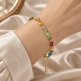 Multicolour crystal gold-plated bracelet laid flat on cream satin