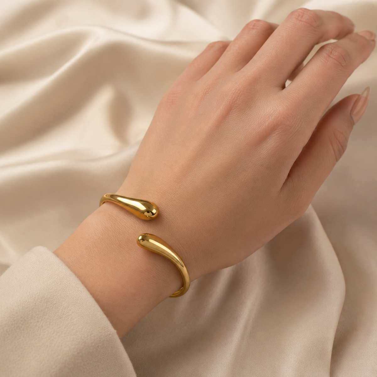 Gold-plated stainless steel open cuff bracelet with smooth rounded ends and clasp detail