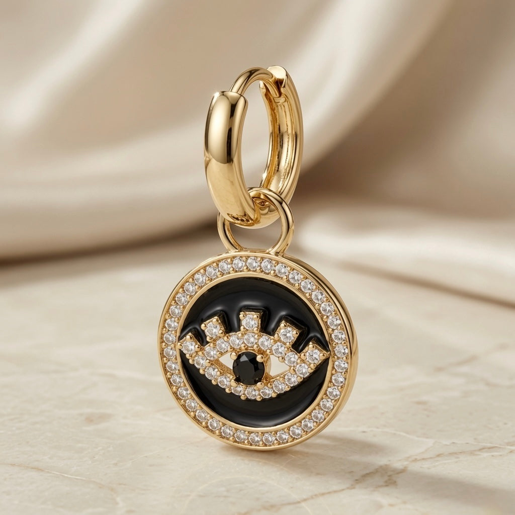 Heart & Evil Eye Mismatched Hoop Earrings - evil eye coin charm close-up on silk backdrop