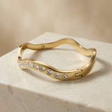 Wave Crystal Bangle - elevated angle showing wave silhouette on marble
