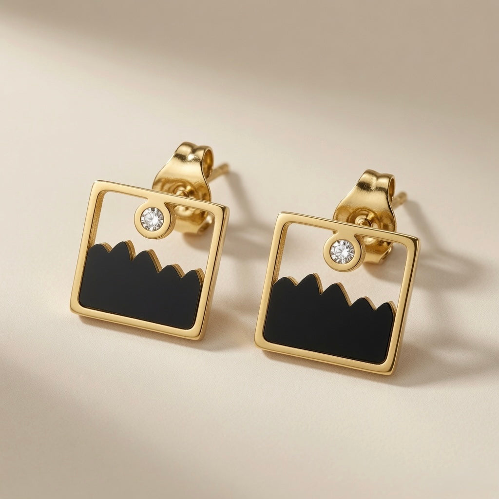 Mountain Horizon Stud Earrings - front flat lay of pair showing mountain silhouette and crystal