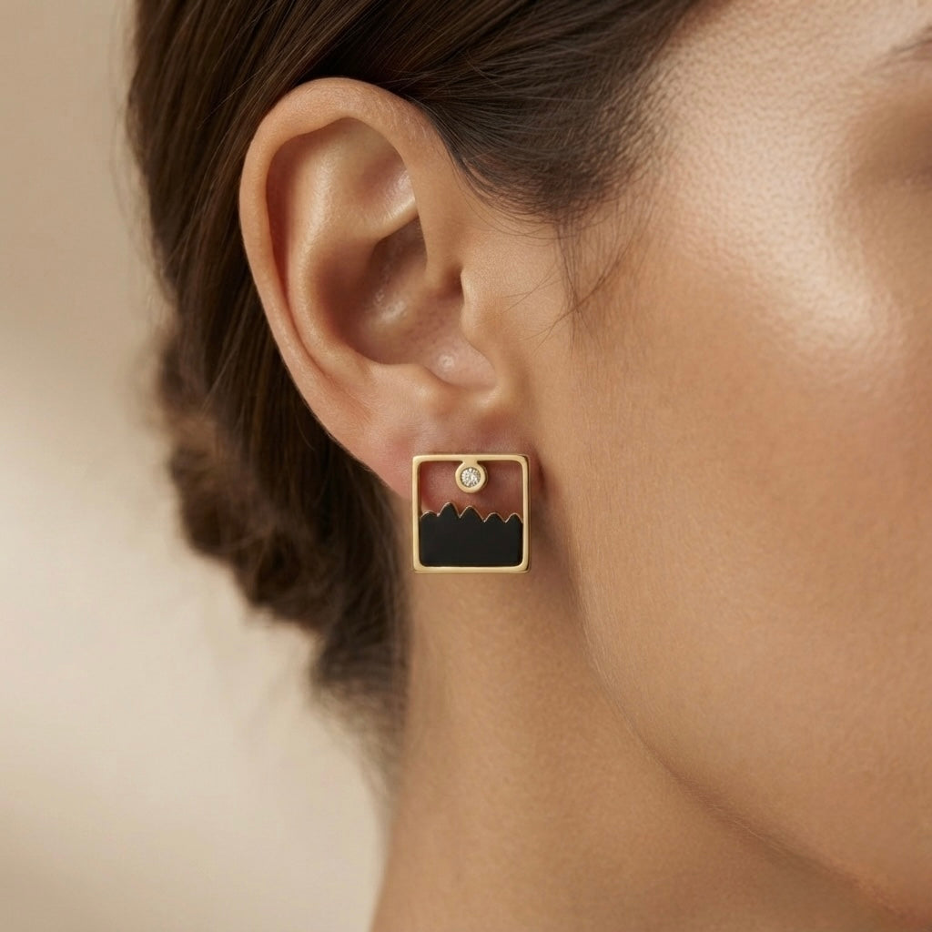 Mountain Horizon Stud Earrings - worn on model ear showing mountain and crystal sun detail