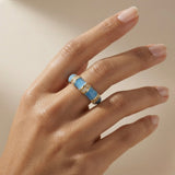 Azure Bamboo Enamel Ring - worn on fair skin model hand showing sky blue enamel and gold connectors