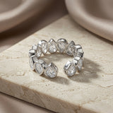 Larme Pear Crystal Eternity Ring - open back view on travertine showing adjustable band and full stone coverage
