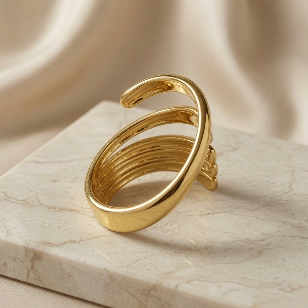 Helix Gold Coil Ring - side view on marble showing open coil ends and spiral silhouette