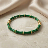 Vert Bamboo Enamel Bangle - flat lay on marble with silk backdrop