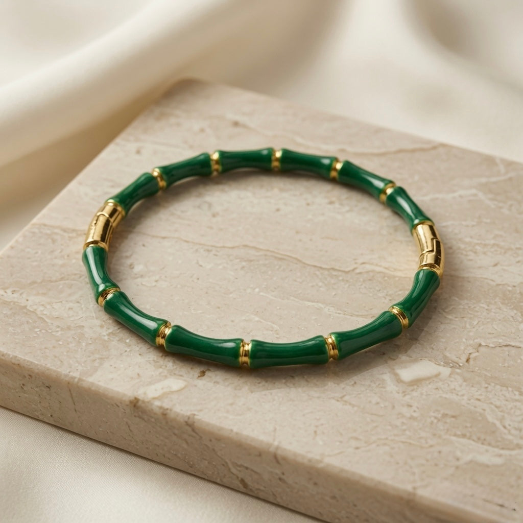 Vert Bamboo Enamel Bangle - elevated flat lay on marble pedestal with silk backdrop