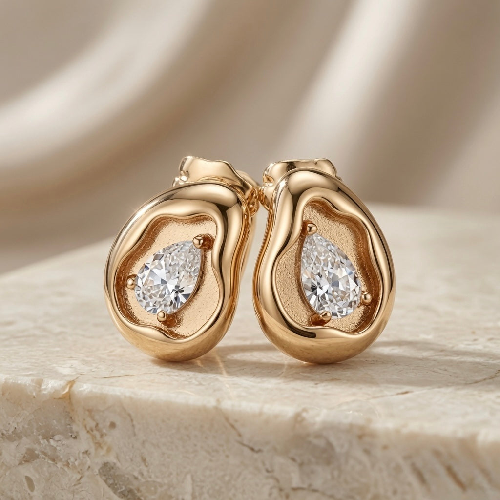 Molten Pear Crystal Stud Earrings - pair front view showing full sculptural form and pear crystal on marble