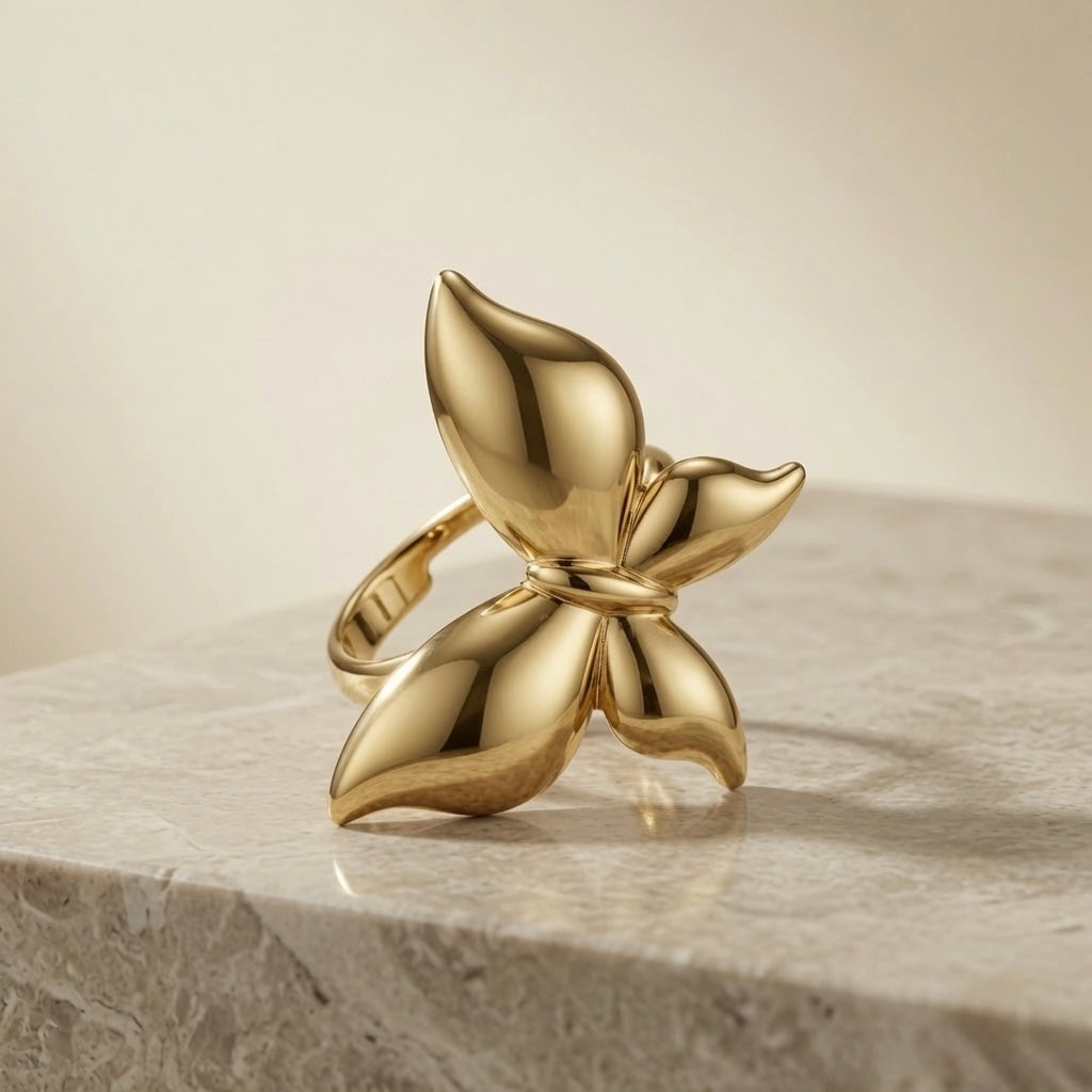 Fleur Gold Bloom Ring - front elevated view on marble showing full four-petal bloom and mirror polish