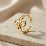 Infinity Bloom Gold Ring - side angle on marble showing open back double band and adjustable ends