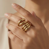 Helix Gold Coil Ring - worn on model hand showing knuckle-grazing profile and warm gold glow