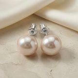 Perle Blush Pearl Stud Earrings Silver - back view on marble with silk showing rhodium silver screw-back fastenings