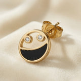 Lunaire Noir Crystal Stud Earrings - single earring on silk showing abstract face motif with crystal eyes and black enamel smile