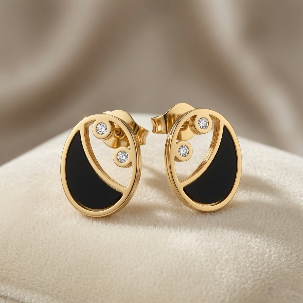 Lunaire Noir Crystal Stud Earrings - pair on sand surface showing full circular disc profile and butterfly backs