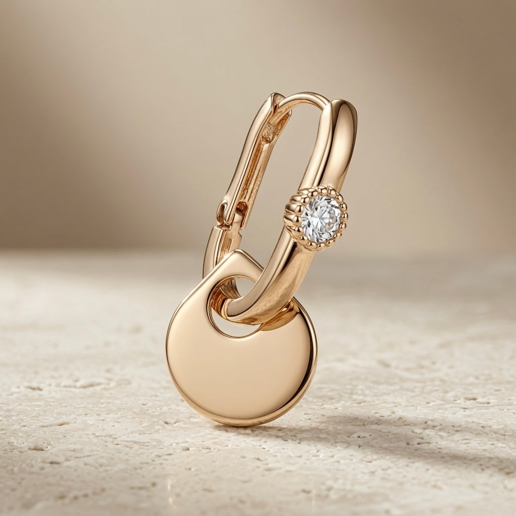 Disque Crystal Huggie Drop Earrings - single earring side profile on travertine showing click-lock huggie and disc drop length