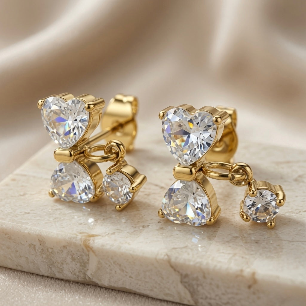 Noeud Crystal Bow Drop Earrings - pair on marble with silk showing heart-cut bow construction and round brilliant drop