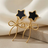 Étoile Noir Bow Drop Earrings - pair on travertine edge showing open wire bow loop construction and trailing tails detail