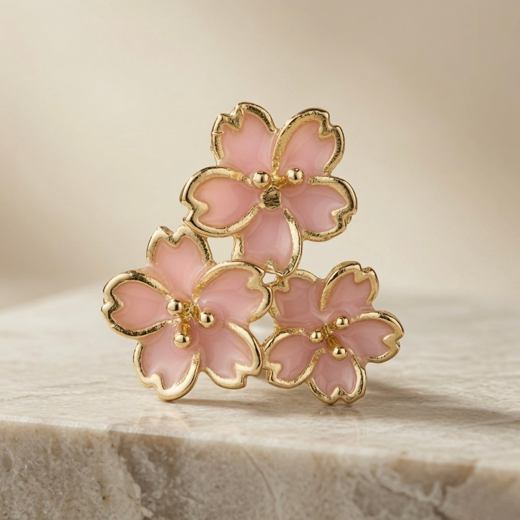 Sakura Bloom Cluster Stud Earrings - single earring front on marble showing triple cherry blossom cluster, notched petals and gold bead stamens