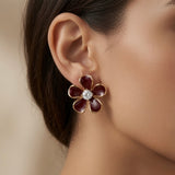 Vigne Crystal Fleur Stud Earrings - worn on model ear showing round brilliant crystal centre, scale and deep burgundy gold contrast against skin