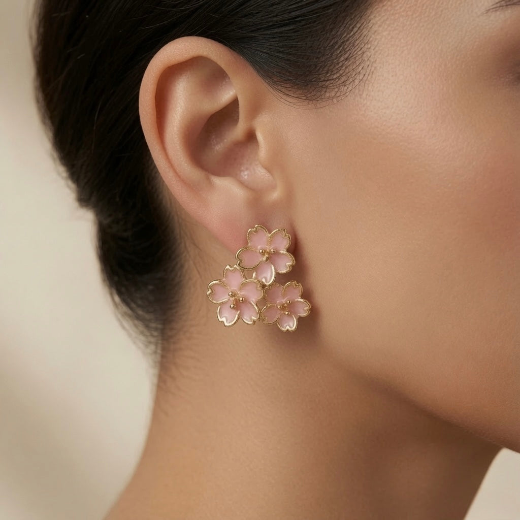 Sakura Bloom Cluster Stud Earrings - worn on model ear showing scale, cascading triangular bloom cluster and blush gold warmth against skin