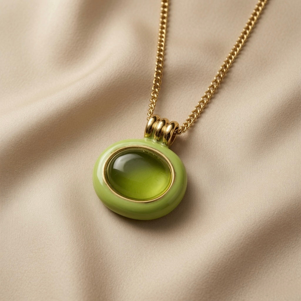 Pistache Cabochon Pendant Necklace - macro on silk showing coiled gold spring bail, inner gold bezel and cabochon crystal depth