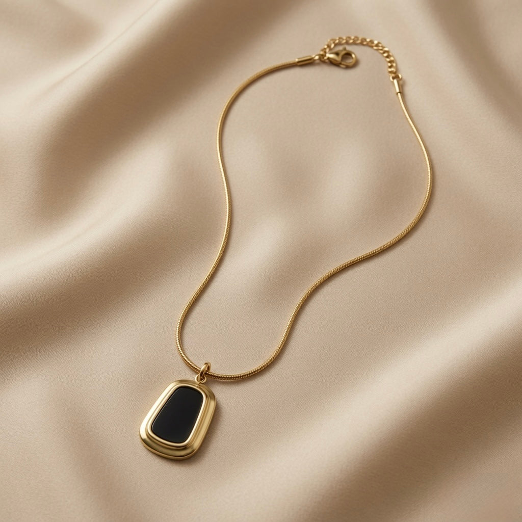 Tableau Noir Pendant Necklace - full flat lay on ivory silk showing complete snake chain, lobster clasp, gold tag extender and pendant