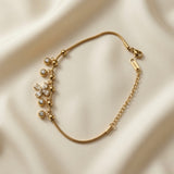 Fleur Cristal Fringe Drop Snake Chain Bracelet - flat lay on ivory silk from alternate angle showing complete bracelet open, Svora logo bar tag on curb extender, lobster clasp and five crystal drop fringe composition