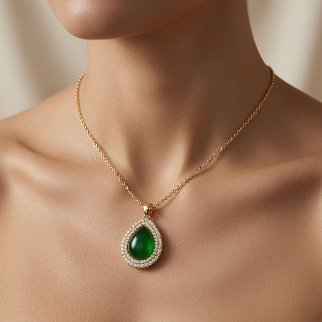 Impériale Jade Pavé Necklace - worn on model collarbone showing emerald green cabochon pendant at chest centre, double halo pavé fire and gold cable chain