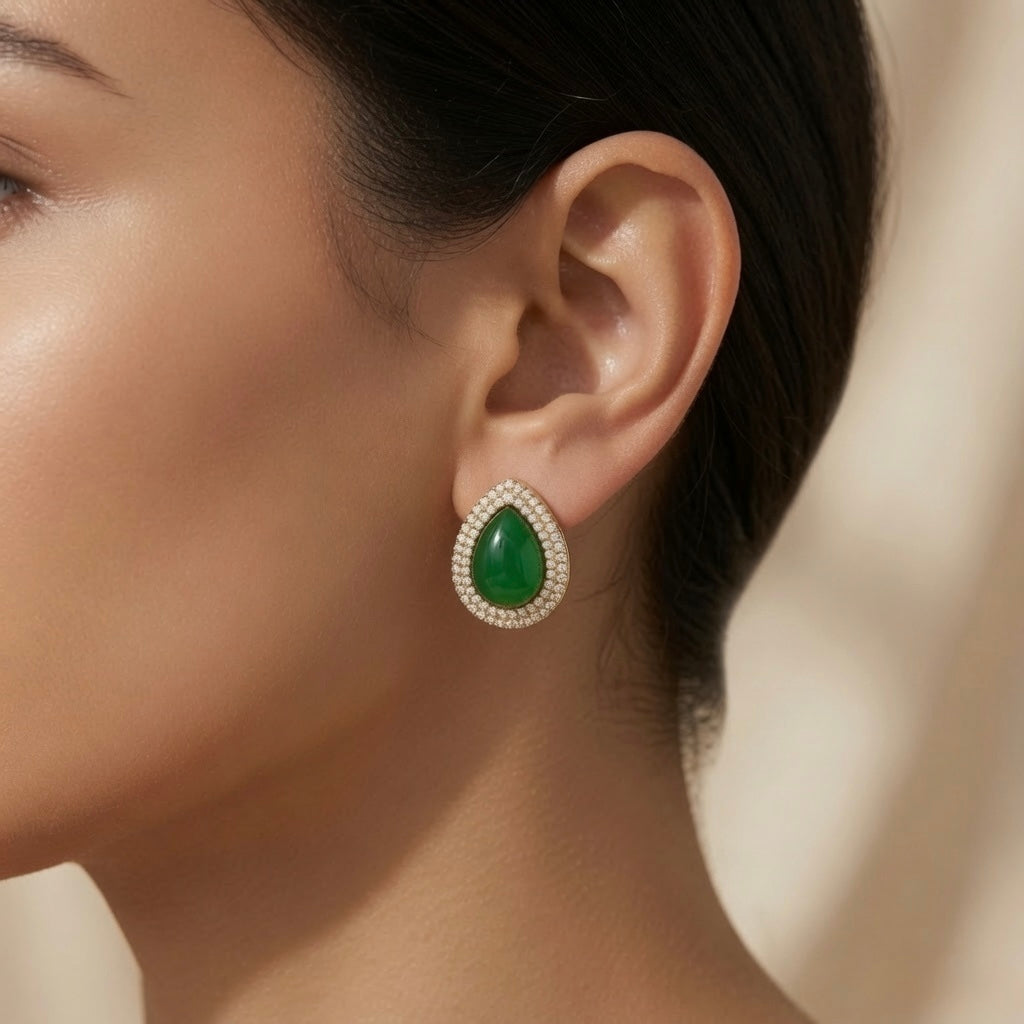 Impériale Jade Pavé Earrings - worn on model ear showing pear cabochon green crystal and double halo pavé stud filling lobe with green and white fire