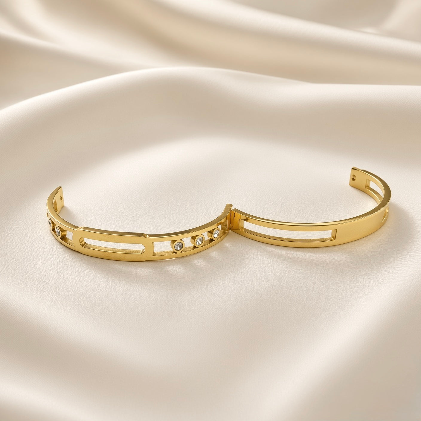 Arcade Crystal Lattice Hinged Bangle Set - both bangles flat lay on champagne silk showing complete set: crystal lattice bangle with five bezel-set crystal zirconia stones (left) and plain lattice bangle without stones (right), both showing identical wide flat-band construction with open-work geometric lattice and hinged clasp