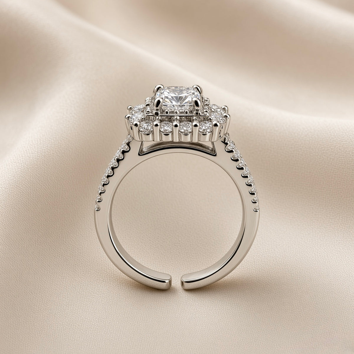 Princess Cut Double Halo Split Shank Adjustable Ring - side profile on ivory satin showing open adjustable band and elevated head: open-C band back construction clearly visible, split shank double-rail pavé band with micro-pavé round white crystals on both rails, elevated square gallery platform below double halo head, princess cut centre stone above