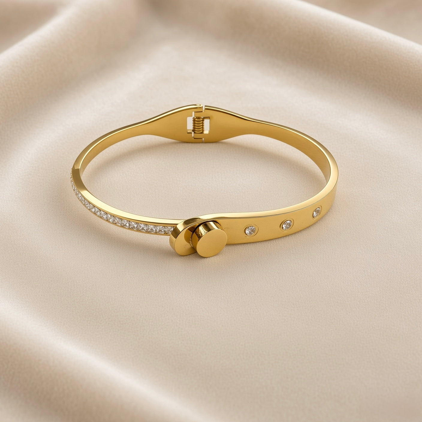 Gold-tone embellished bangle showing clear square accents and clasp-style centre detail