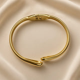 Gold-plated stainless steel cuff bracelet showing the clasp and open cuff design
