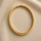 Side view of a gold-plated stainless steel bangle bracelet with sparkling clear stone rows