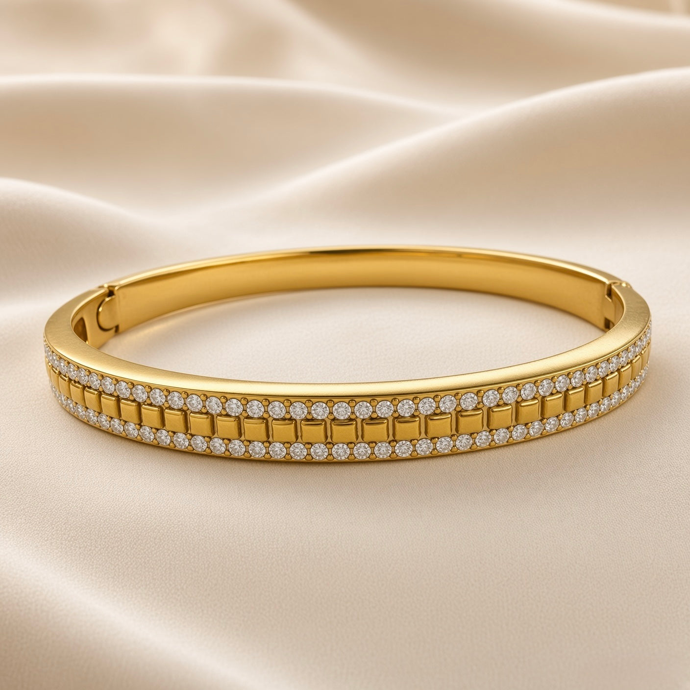 Close-up of geometric gold-plated bangle bracelet with clear decorative stones