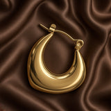 Chunky Crescent Moon Hoop Earrings Gold Mirror Polish - pair flat lay on dark brown satin second angle: both hoops showing full crescent moon silhouette with wide convex front faces, deep concave inner arcs, click-hoop lever clasps, warm 18K gold mirror-polish surface with broad reflective warm gold light
